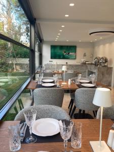 a restaurant with tables and chairs and a large window at Brasil Suites Boutique Hotel in Athens
