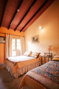 a bedroom with two beds and a window at Hotel Santo Domingo in Asuncion