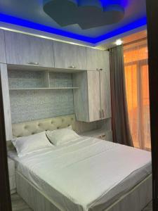 a bedroom with a large bed with a blue ceiling at My Sweet Home In Rustavi sity 2 in Rustavi