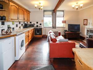 a living room with a red couch in a kitchen at Highview in Keighley