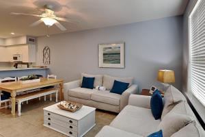 a living room with a couch and a table at The Village 514 in Blue Mountain Beach