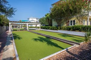 an artificial lawn in front of a house at The Village 514 in Blue Mountain Beach