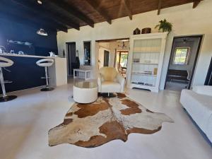 a living room with a large rug on the floor at The Retreat Swellendam in Swellendam
