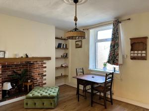 a dining room with a table and a chair at Idyllic Retreat in Dalton-In-Furness Sleeps 3! in Dalton in Furness