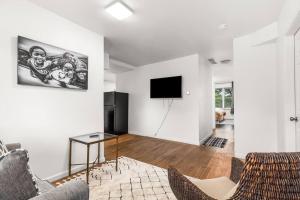 a living room with a couch and a tv at Opulent 2 Bedroom Getaway in Detroit