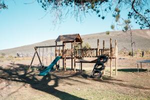a park with a playground with a slide and a swing at Drie Kuilen Nature Reserve in Touwsrivier