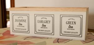 two labels in a wooden box on a table at "La Villa dei Nonni" appartamento in Bergamo