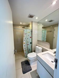 a bathroom with a toilet and a sink and a mirror at City Center Residence - Pool view in Pattaya Central