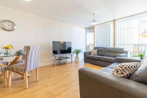 a living room with a couch and a table at Cotels at Vizion Serviced Apartments, Superfast Broadband, Central Location, Free Parking, Fully Equipped Kitchen in Milton Keynes