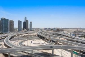 a highway in a city with many cars at StoneTree - Stylish 1BR near Marina Walk in Dubai