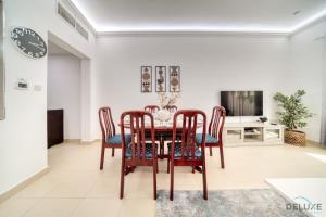 a dining room with a table and chairs at Ritzy 1BR at Global Golf Residence 2 Sports City by Deluxe Holiday Homes in Dubai