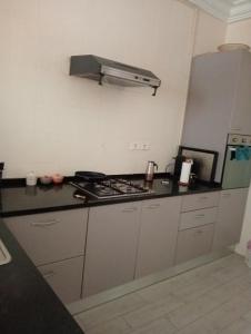 a kitchen with a stove and a counter top at Mia casa in La Goulette