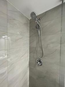 a shower with a shower head in a bathroom at Toronto GREAT Located in Toronto
