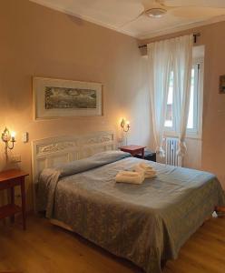 a bedroom with a bed with two towels on it at Hotel Dali in Florence