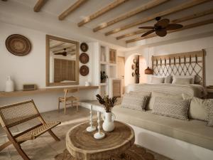 a bedroom with a bed and a table and a couch at Lesante Cape Resort & Villas - The Leading Hotels of the World in Akrotiri