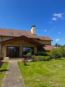 a house with a brick walkway in front of it at Borovik in Novosilki