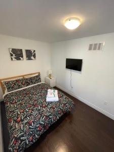 a bedroom with a bed and a flat screen tv at Toronto GREAT Located in Toronto