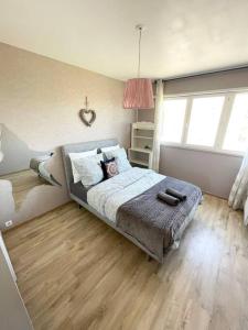 a bedroom with a bed with a wooden floor at Grand appartement idéalement situé in Villeurbanne