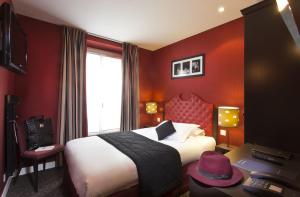 a hotel room with a bed with a hat on it at Hôtel Du Prince Eugène in Paris