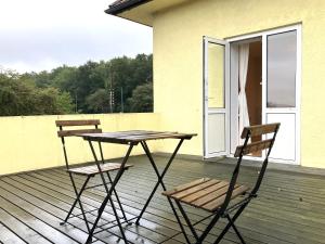 a table and two chairs sitting on a deck at One Bedroom Apartment In Odense, Middelfartvej 259 in Odense