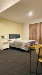 a bedroom with a large bed and a table at Templo de la Luna in Cusco