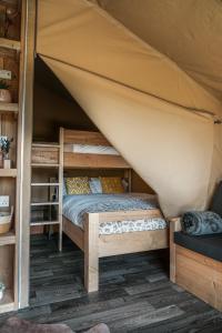 a bedroom with a bunk bed in a tent at Glamping at Macdonald's Farm in Saint Ervan