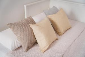 three pillows sitting on a bed in a bedroom at APT per coppie nel cuore di Desenzano CASTELLO in Desenzano del Garda