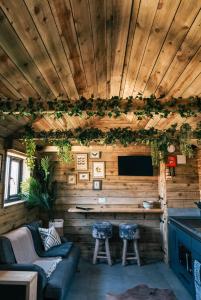 a living room with a couch and a bar at The Potting Barn in Saint Ervan
