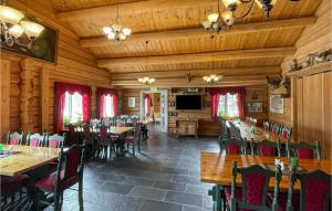 a dining room with wooden tables and chairs at Gorgeous Home In Grue Finnskog With Kitchen in Svullrya
