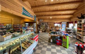 a grocery store with wooden ceilings and a grocery store aisle at Gorgeous Home In Grue Finnskog With Kitchen in Svullrya