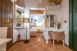a room with a bedroom with a bed and a desk at The Varos Residences Hotel in Város