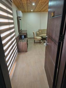 a hallway with a living room with a chair and a table at Sunset Hotel in Wadi Musa