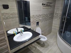 a bathroom with a sink and a toilet and a shower at Sunset Hotel in Wadi Musa