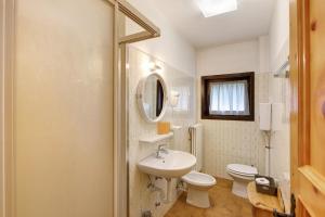 a white bathroom with a sink and a toilet at Residence Valleverde in Livigno +20 photos