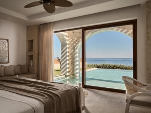 a bedroom with a bed and a view of the ocean at Lesante Cape - The Leading Hotels of the World in Akrotiri +137 photos