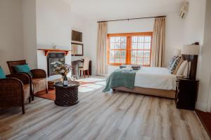 a bedroom with a bed and a living room at Manley Wine Estate in Tulbagh