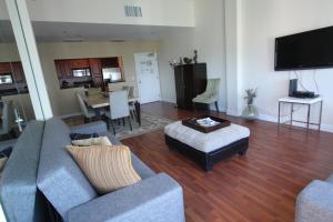 a living room with a couch and a table at 2 BD Penthouse with Balcony in Miami Beach