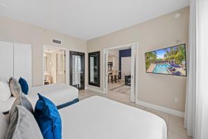 a bedroom with two beds and a living room at The Sagamore Hotel South Beach in Miami Beach