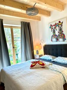 a bedroom with a bed with two stuffed animals on it at DIE ZWEI CHALETS AM TEGERNSEE "s' Gloane" & "s' Große" in Rottach-Egern