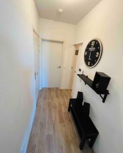 Pokój z zegarem na ścianie i ławką w obiekcie Appartement T2 + parking privatif - Centre ville w Bajonnie