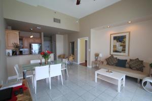 a living room with a table and a couch at Castle Ph2 Balcony Oceanfront Condo, Beach Access, Pool, Tennis, Free Parking in Miami Beach