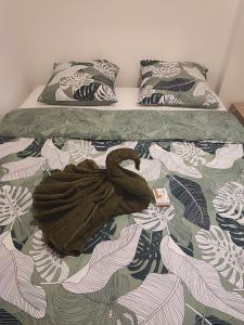 a brown towel laying on top of a bed at Appartement Clos du bois in Fort-de-France