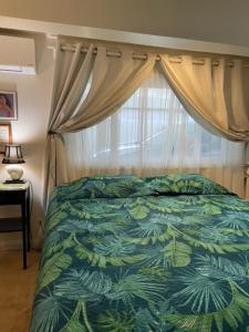 a bedroom with a bed and a window at Kalama Room in Kailua