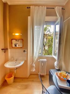 a bathroom with a sink and a window at Hotel Dali in Florence