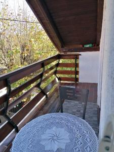 a table and a chair on a balcony at Studio Apartman Barbara in Josipdol +7 photos