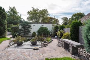 a garden with a stone bench and a fence at Haus Berger in Wehr