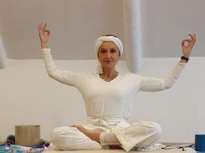 a woman sitting on the floor with her hands in the air at The Retreat Swellendam in Swellendam