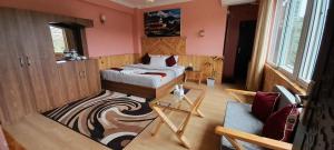 a small bedroom with a bed and a couch at Paradise Villa in Nagarkot