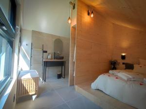 a bedroom with a bed with a wooden wall at L'Echappée Magique in Mandray