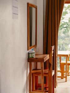 a wooden table with a mirror on a wall at Meexok river view in Nongkhiaw